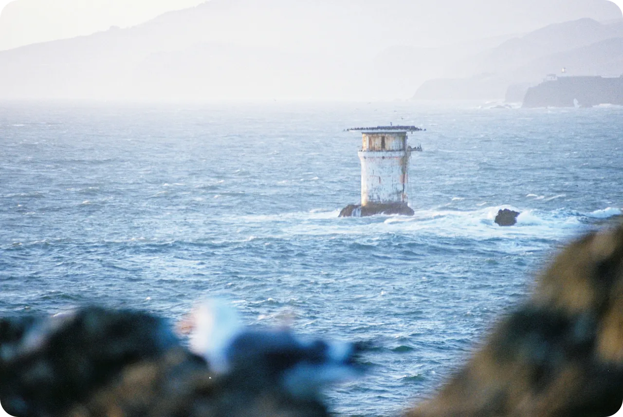 Ocean view near San Francisco with a small tower in the water.